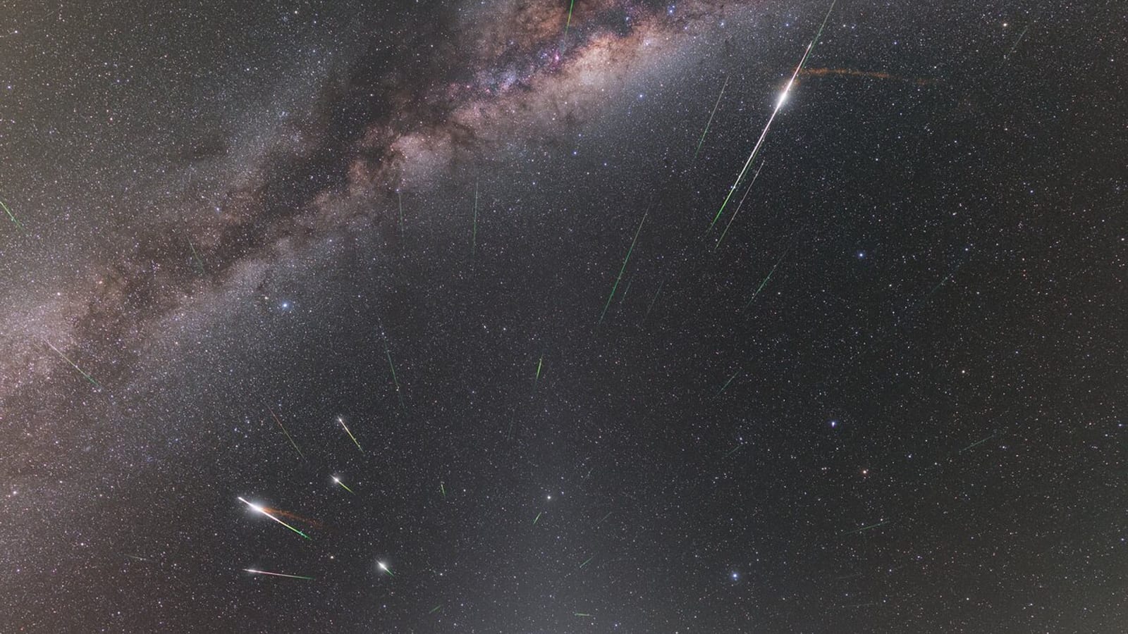Long-exposure photograph of bright Eta Aquariid meteor trails radiating from the constellation Aquarius over the Atacama Desert in Chile, with the Milky Way and four bright planets visible